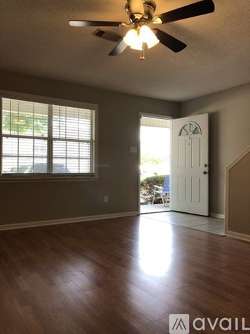 Valdosta apartment for rent - A kitchen with wooden cabinets and a black stove top oven.
