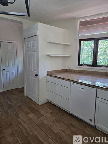 Mount Jackson apartment for rent - A kitchen with white cabinets and a brown floor.