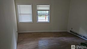 Mount Jackson apartment for rent - A room with wooden flooring and two windows.