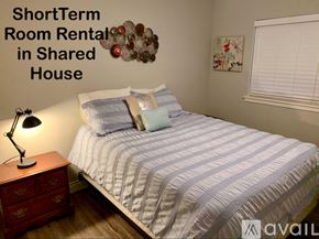 Lubbock house for rent - A bedroom with a bed, nightstand, and lamp is advertised for short-term room rental in a shared house.