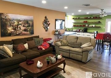 Lubbock house for rent - A living room with a brown couch and a coffee table in front of it.