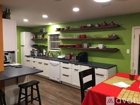Lubbock house for rent - A kitchen with green walls and white appliances.