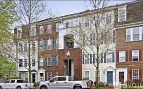 Alexandria condo for rent - A row of townhouses with cars parked in front.