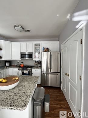 Alexandria condo for rent - A kitchen with granite countertops and stainless steel appliances.