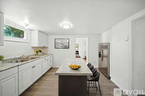 College Place apartment for rent - A room with a window and wooden flooring.