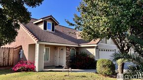 Lemoore house for rent - A backyard with a fence and a house.
