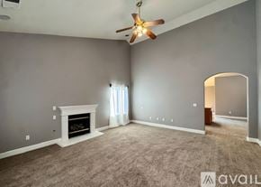 Lemoore house for rent - A living room with a fireplace and a window.