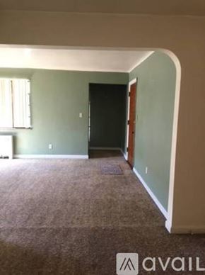 Cincinnati apartment for rent - A room with a carpeted floor and a black door.