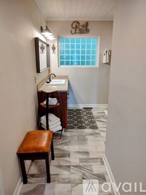 Scaly Mountain house for rent - A bathroom with a sink, mirror, and a window.