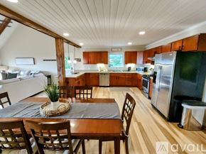 Scaly Mountain house for rent - A kitchen with wooden floors and a dining table set for four.