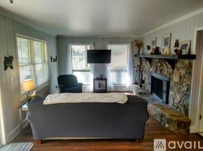 Sky Valley apartment for rent - A bedroom with a large bed and a stone fireplace.