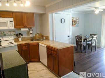 Sky Valley apartment for rent - A kitchen with wooden cabinets and a white stove top oven.