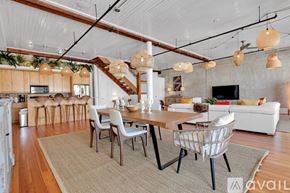 Savannah apartment for rent - A modern dining room with a wooden table and chairs.