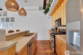 Savannah apartment for rent - A kitchen with wooden cabinets and a stainless steel refrigerator.