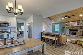 Clayton house for rent - A modern kitchen with a wooden ceiling and a dining table with chairs.