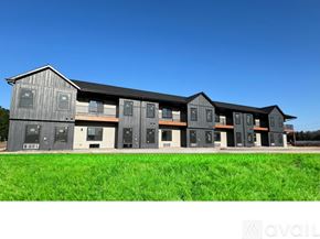 Altoona apartment for rent - A row of modern buildings with grey exteriors and white doors.
