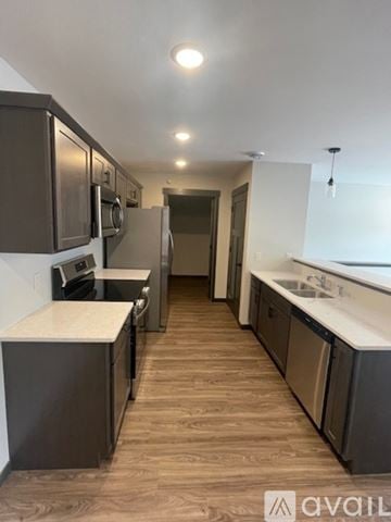 Altoona apartment for rent - A kitchen with dark brown cabinets and a white countertop.