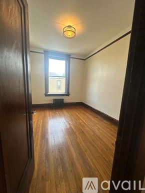 Oswego apartment for rent - A room with wooden floors and a window.