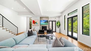 , Beverly Hills house for rent - A living room with a grey couch and a black coffee table.