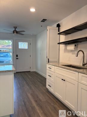 Blanco apartment for rent - A kitchen with white cabinets and a stainless steel dishwasher and stove.