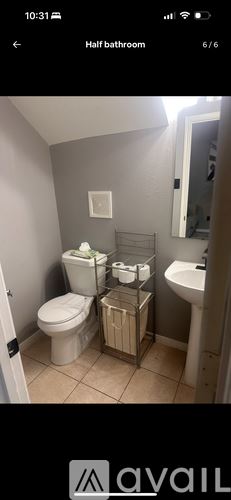 Houston townhouse for rent - A bathroom with a toilet, sink, and towel rack.