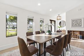 Lighthouse Point house for rent - A modern dining room with a wooden table and chairs.