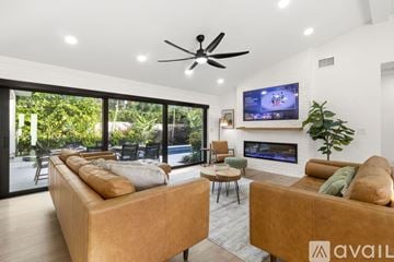 Lighthouse Point house for rent - A modern living room with a large sofa and a wooden chair.