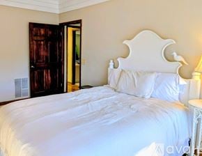 Dillard apartment for rent - A bedroom with a bed and a stone wall.