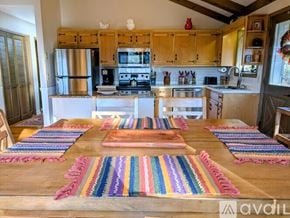 Dillard apartment for rent - A dining room with a table set for six and a chandelier hanging from the ceiling.