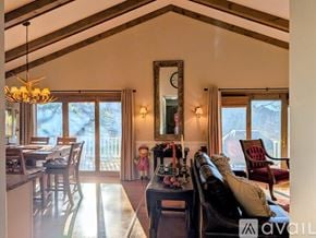 Dillard apartment for rent - A large wooden dining table is surrounded by chairs in a spacious kitchen.