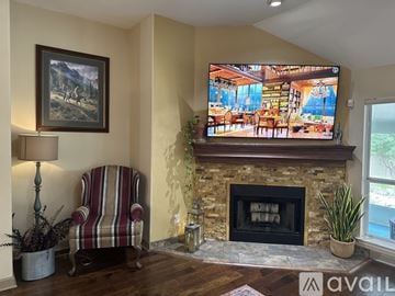 Schertz house for rent - A living room with a fireplace and a painting on the wall.