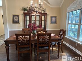 Schertz house for rent - A dining room with a wooden table and chairs.