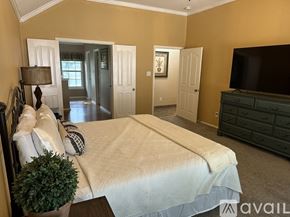 Schertz house for rent - A bedroom with a large bed and a television.