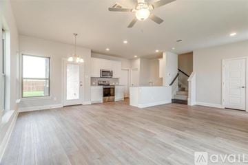 Mansfield house for rent - A spacious living room with a fan and lighting fixtures.