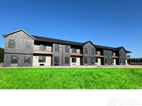 Altoona apartment for rent - A row of modern buildings with grey exteriors and white doors.