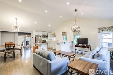 Atlanta house for rent - A living room with a grey couch and a wooden coffee table.