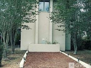 Tampa house for rent - A small house with a red brick pathway leading to the front door.