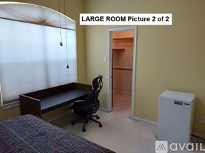 Houston house for rent - A room with a bed, desk, and chair.