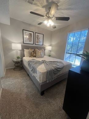 Weatherford apartment for rent - A bedroom with a bed, nightstand, and two framed pictures on the wall.