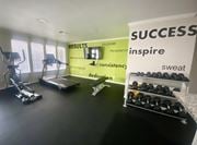 Denton apartment for rent - A gym room with a sign that says "SUCCESS" on the wall.