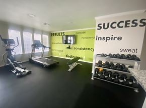 Denton apartment for rent - A gym room with a sign that says "SUCCESS" on the wall.