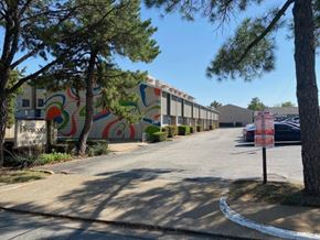 Arlington apartment for rent - A street view of a residential area with a colorful mural on the wall.