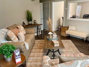 Fort Worth apartment for rent - A living room with a sofa, armchair, and coffee table.