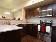 Sherman apartment for rent - A kitchen with dark brown cabinets and a stainless steel oven.