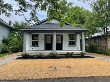 Indianapolis house for rent - A small house with a black door and white trim.