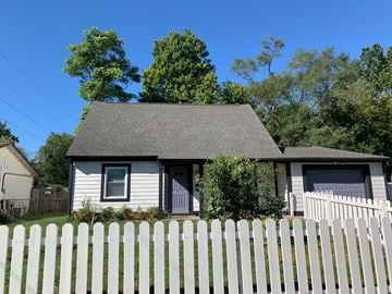 Indianapolis house for rent - A house with a grey roof and a white picket fence.