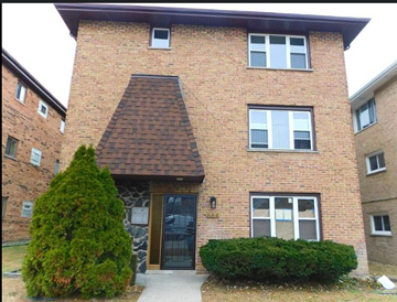 Calumet City apartment for rent - A red brick house with a triangular roof and a small front yard.