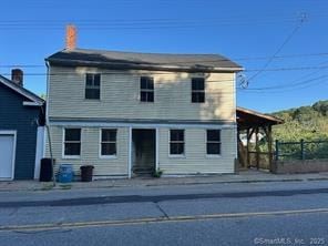 Norwich apartment for rent - A two-story house with a white front and a blue garage door.