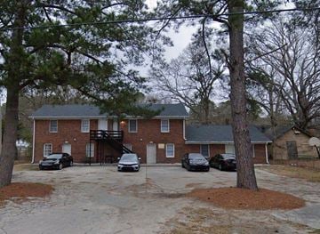 Rocky Mount apartment for rent - A house with a driveway and cars parked in front.