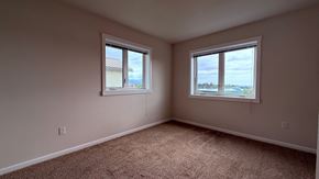 Sitka house for rent - A room with two windows and carpeted floor.